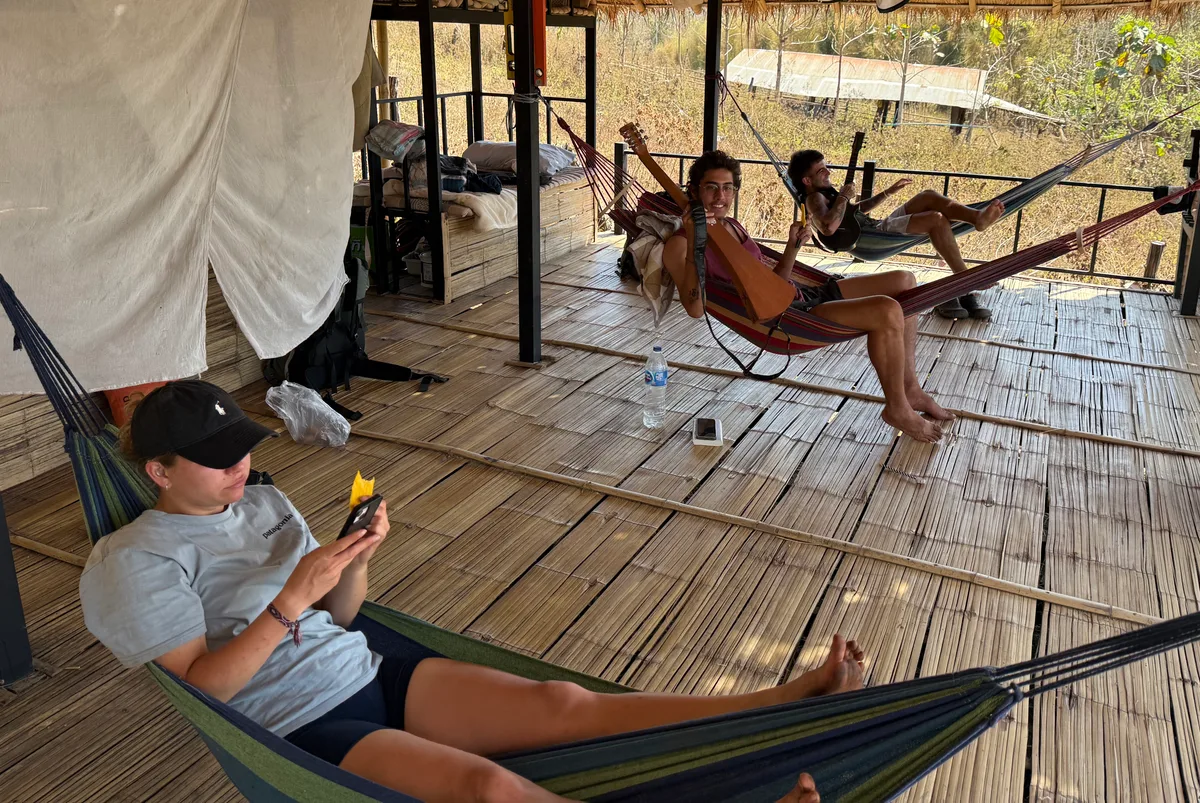 Guests relaxing together on the open-air bamboo sleeping deck at Bungalows & Bunks in Pai.