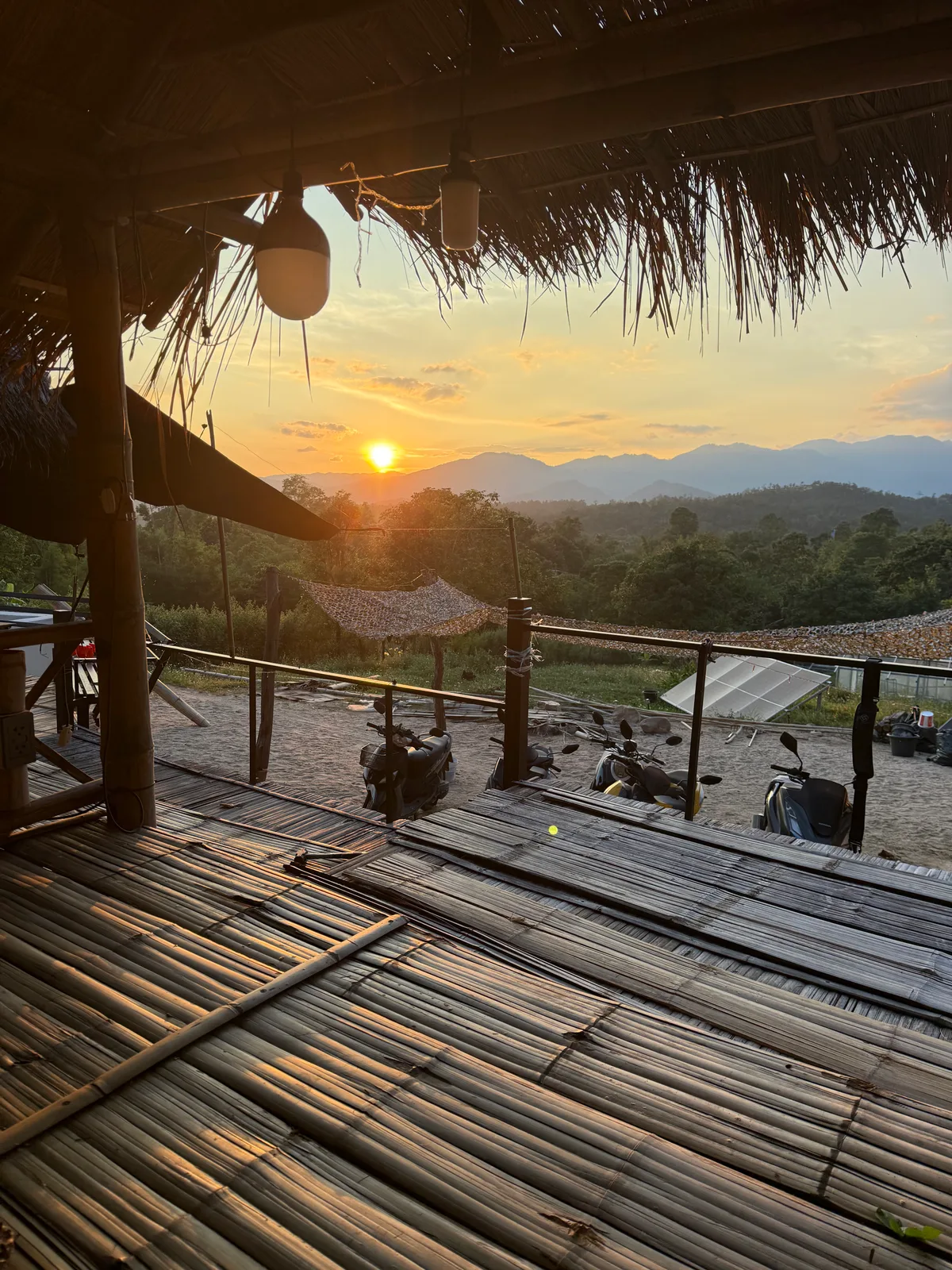 Sunset mountain views from the open-air bungalow deck at Bungalows & Bunks in Pai.