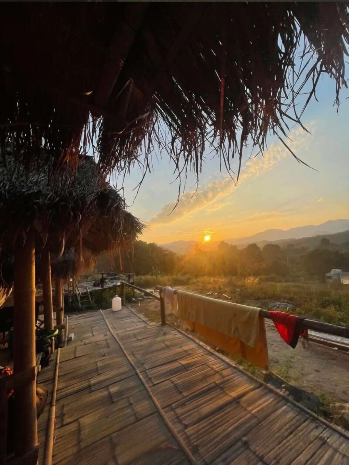 Sunset over the hills from the bamboo terrace at Bungalows & Bunks in Pai.